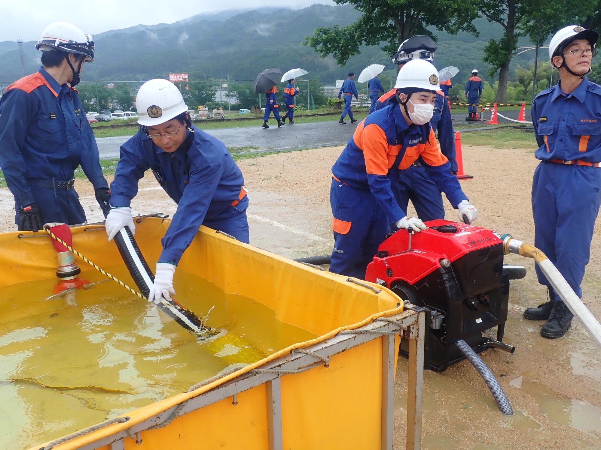 可搬ポンプを操作する消防団員